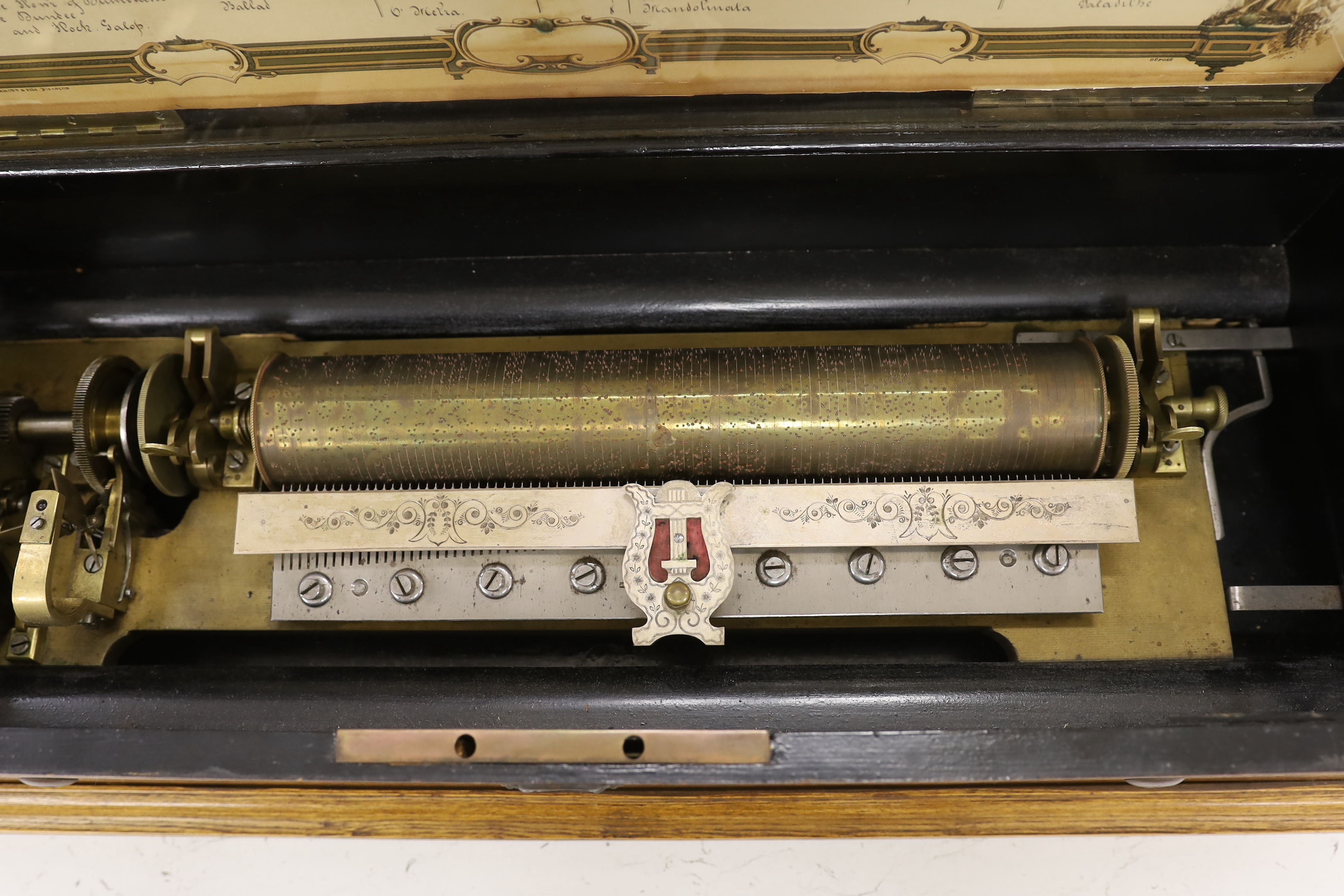 A late 19th century Swiss musical box with 92 tooth comb (one tooth broken and missing), with eight tune 13 inch cylinder and two additional cylinders, the case re-veneered in oak, 79cm wide